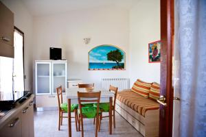 a living room with a table and a couch at Miriacheddu in San Teodoro
