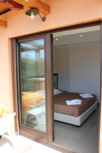 a bedroom with a bed through a glass door at Park Hotel Cilento in Marina di Camerota