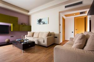 a living room with a couch and a table at Elite City Resort in Kalamata