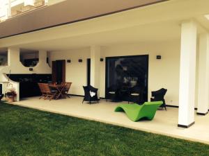 a patio with chairs and a table in a yard at Gl106 in Santa Severa