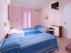 Postel nebo postele na pokoji v ubytování Hotel Miramare