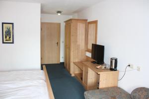 a bedroom with a bed and a television on a desk at Ferienunterkunft Landshut-Altdorf in Landshut