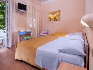 Postel nebo postele na pokoji v ubytování Hotel Miramare