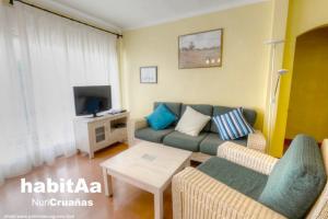 a living room with a couch and a tv at Quintas de Sant Pol, a 50 metros de la playa de Sant Pol E29049 in Sant Feliu de Guíxols