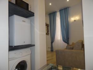 a living room with a washing machine and a couch at Suites Margot in Santa Margherita Ligure