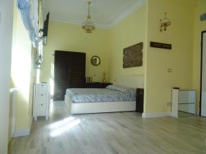 a bedroom with a bed and a wooden floor at Suites Margot in Santa Margherita Ligure