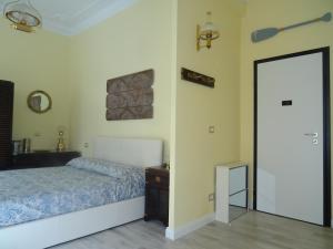 a bedroom with a bed and a mirror at Suites Margot in Santa Margherita Ligure