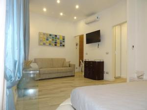a living room with a bed and a couch at Suites Margot in Santa Margherita Ligure