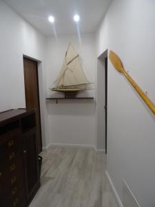 a baseball bat and a boat hanging on a wall at Suites Margot in Santa Margherita Ligure