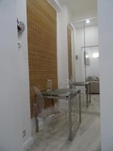 a dining room with a glass table and chairs at Suites Margot in Santa Margherita Ligure
