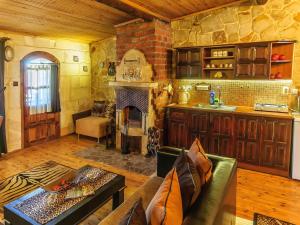 a living room with a couch and a fireplace at Adanos Konuk Evi in Avanos