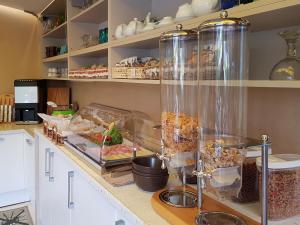 a kitchen with a counter with food in glass containers at Garda Dream in Lazise