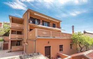 a large orange building with a balcony on it at Apartments Valiža 2 in Senj
