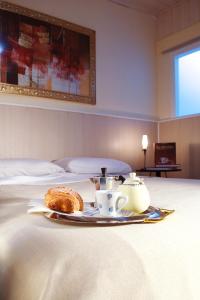 a tray with a tea set on top of a bed at Vacanze Cassibile in Cassibile