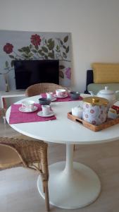 a white table with bowls and dishes on it at Vittadinisette in Pavia
