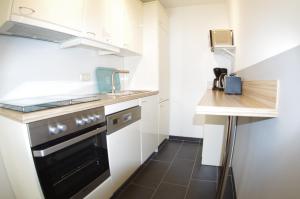 a small kitchen with a sink and a stove at Relaxzone 202 - Hohen Wieschendorf in Hohen Wieschendorf