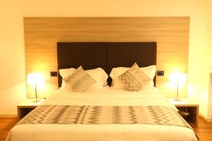 Postel nebo postele na pokoji v ubytování Hotel Nuvola