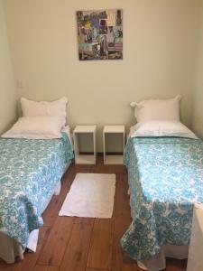 Cama ou camas em um quarto em Vila Stellino Suítes