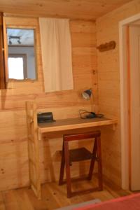 a wooden desk in a room with a window at Petit appartement en montagne in Saint-Julien-en-Champsaur