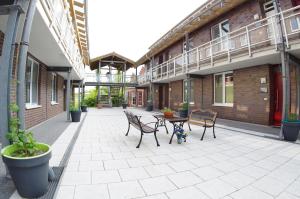 a patio with chairs and a table in a building at Relaxzone 202 - Hohen Wieschendorf in Hohen Wieschendorf