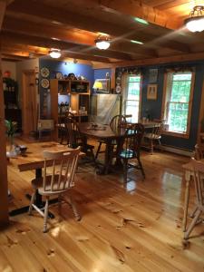 a dining room with wooden floors and tables and chairs at Blueberry Fields Bed & Breakfast in Jefferson