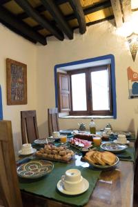 a table with plates of food on it at El Cobijo de Vejer in Vejer de la Frontera