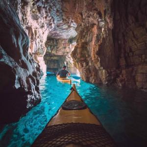 a man in a kayak in a cave at Studio Apartment Slavi in Pula
