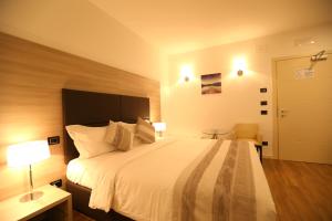 Postel nebo postele na pokoji v ubytování Hotel Nuvola