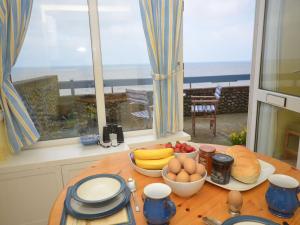 a kitchen with a table with eggs and fruit on it at Sea View 3 Promenade in Sheringham