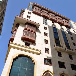 a tall white building with windows on top of it at Rotana Al Mesk Hotel in Medina