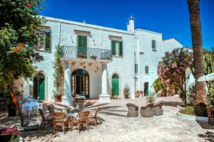 a patio with chairs and a table in front of a building at Masseria Il Frantoio in Ostuni