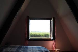 a bedroom with a window in a attic at Casone Maranghetto in Marango di Caorle