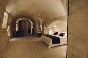 a bedroom with a large bed in a tunnel at Palazzotto Residence&Winery in Matera