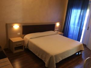 Кровать или кровати в номере Hotel Grifone