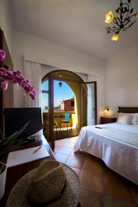a bedroom with a bed and a view of a balcony at Agriturismo Antico Casale Colli Di San Pietro in Piano di Sorrento