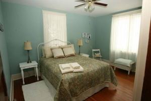 a bedroom with a bed with two towels on it at Highlands Four Season Resort in Calabogie