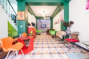 a restaurant with colorful chairs and tables in a room at Zhizhu Homestay in Tainan