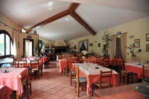 a restaurant with tables and chairs with red table cloth at Affittacamere B&B Trattoria della Posta in Maissana