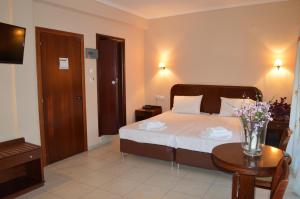 Postel nebo postele na pokoji v ubytování Hotel Strimoniko