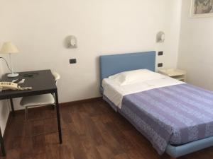 Postel nebo postele na pokoji v ubytování Hotel Nettuno