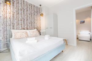 Posteľ alebo postele v izbe v ubytovaní Apartamenty City.