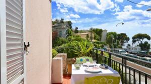 una mesa en un balcón con vistas a la calle en Residence les Lauriers en Niza