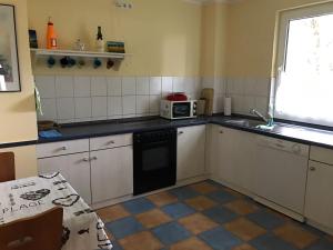 a kitchen with a sink and a microwave at Ferienhaus- Dallgow in Dallgow