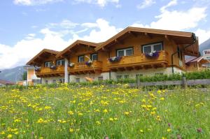 dom na wzgórzu z polem kwiatów w obiekcie Chalet Tirolerland w Mayrhofen
