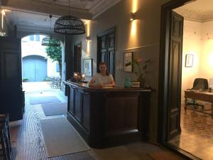 a man sitting at a bar in a room at Le Voyageur - Chambres d'Hôtes in Olonzac