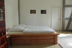 a bedroom with a bed with a wooden bed frame at Gästehaus Tobringen 20 in Tobringen
