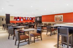 a dining room with tables and chairs at Comfort Inn & Suites near Stadium in Bronx