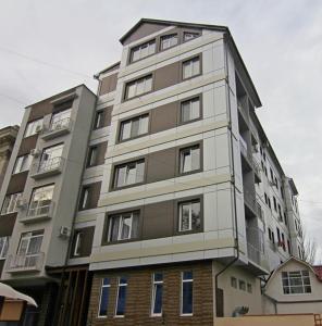 
a large building with a large window on top at Main Street Apartments in Chişinău
