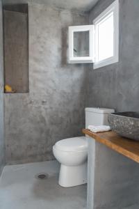 a bathroom with a white toilet and a sink at Aretousa Deluxe Downtown Apartment in Skala
