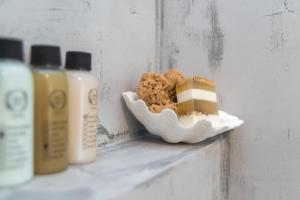 a shelf with a plate of food and bottles of soap at Aretousa Deluxe Downtown Apartment in Skala